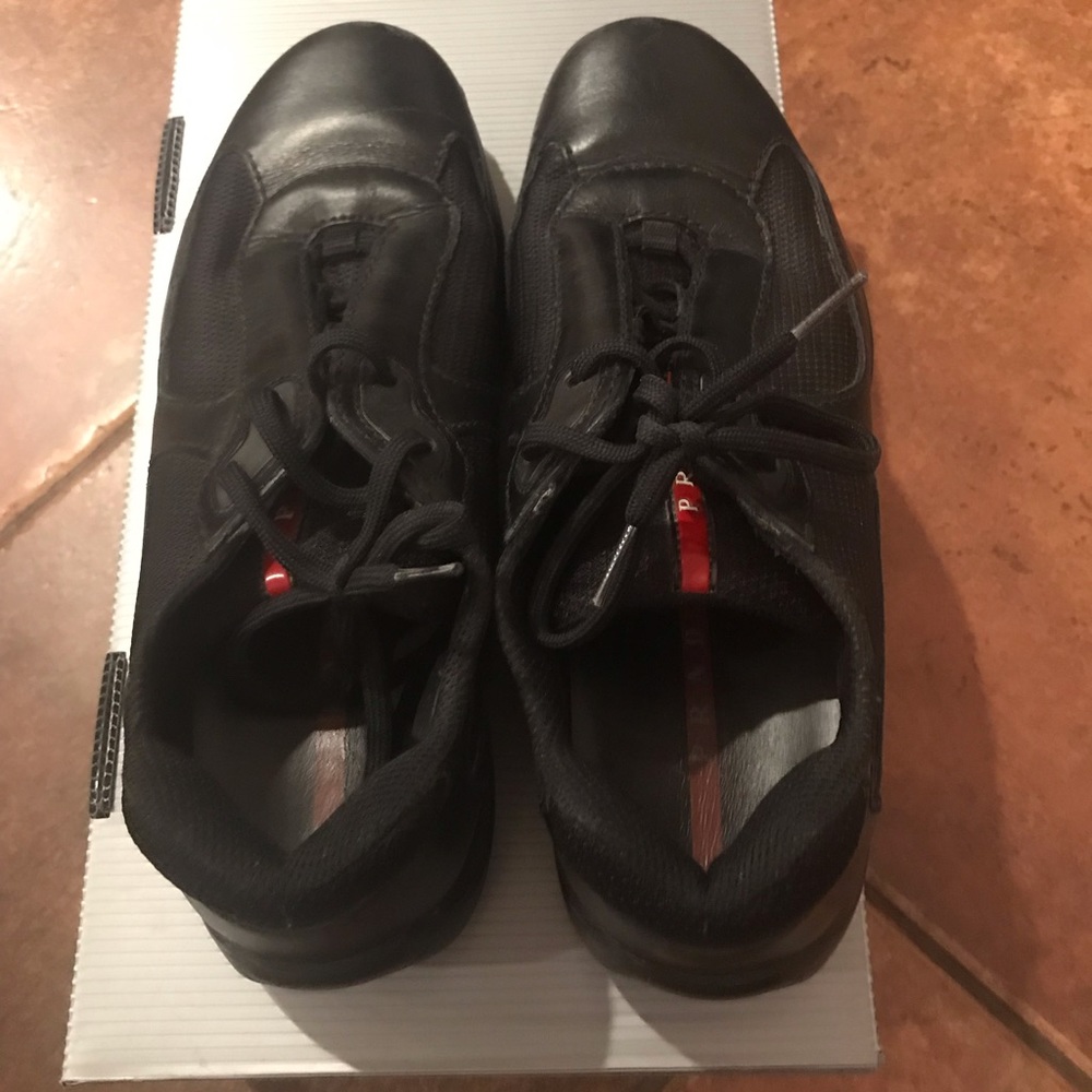 Worn men’s authentic Prada lace up sneakers.